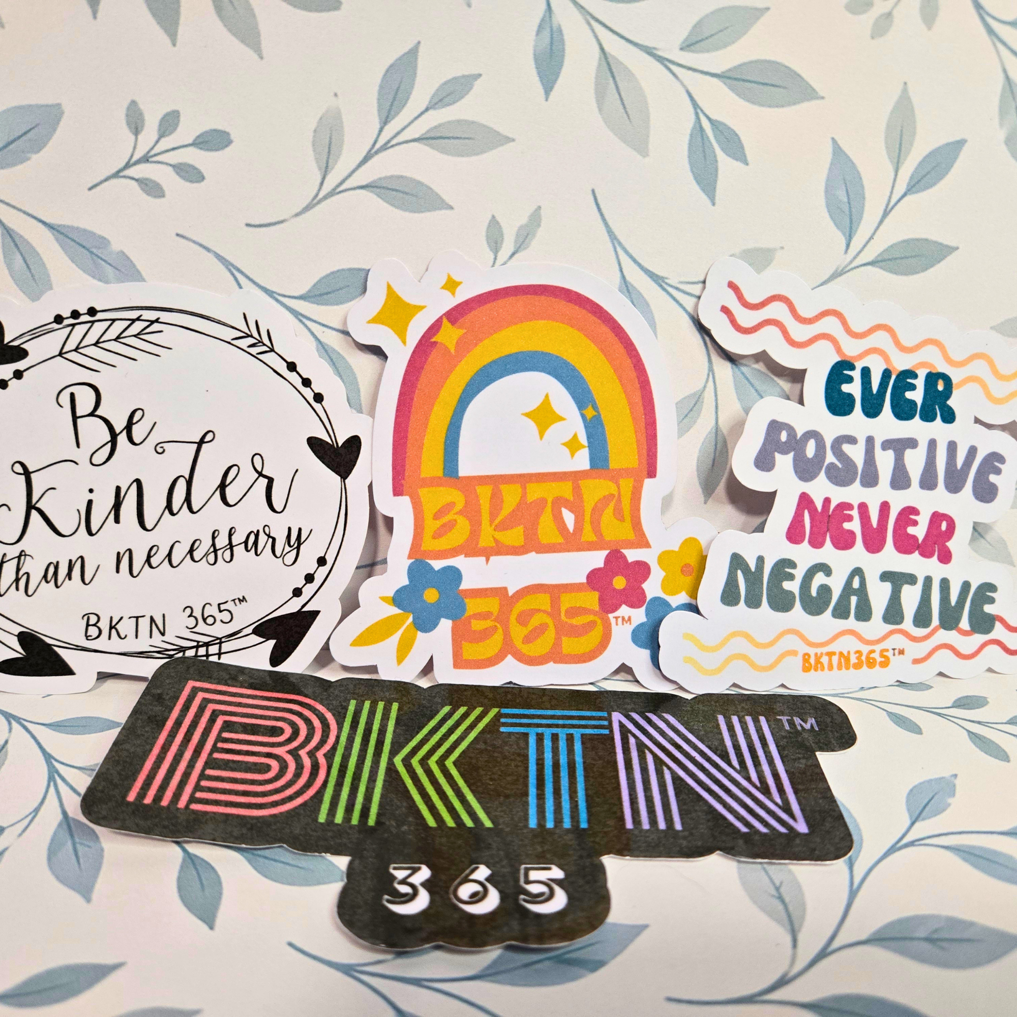 Set of colorful stickers with 'BKTN 365' branding on a floral background